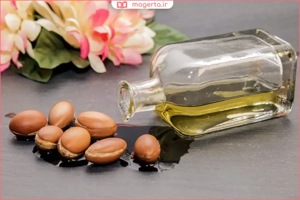 زن در حال مالیدن روغن آرگان روی موهای نم‌دار پس از حمام